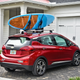 A Bolt sitting in a driveway with its vacation gear secured on the roof, with no fear of being stolen because it’s “one of those electric vehicles.”